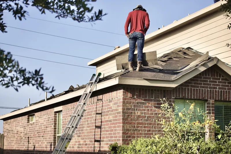 Professional roofer working on a residential roof in Patchogue